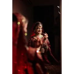 A beautiful bridal portrait captured in the mirror, reflecting the bride's joy and anticipation on her wedding day.