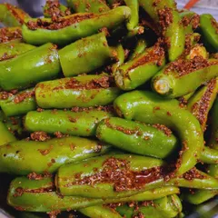 This is my Bharwa Hari Mirch achaar. I carefully stuff each fresh green chili with a flavourful masala mix that is spicy but not overpowering. It's a real treat for those who love a bit of heat.
