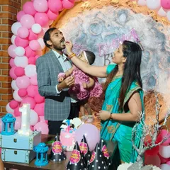 The cake-cutting moment at Mishika's moon-themed first birthday. We love capturing these sweet family interactions.