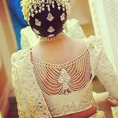 A close-up of the intricate pearl and embroidery work on a custom blouse back. We specialize in detailed designer blouses, including delicate back patterns and unique embellishments.