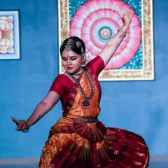 Another moment from the Natyanjali recital, this pose captures the grace and expansive energy of the dance. The vibrant colors of the costume and the artistic background came together to create a beautiful visual story on stage.