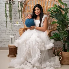 A beautiful portrait of a new mother holding her baby in our boho studio.