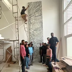 My team and I are installing a large, sculpted stone panel inside a client's home. This feature was designed to bring the texture and character of the adjacent quarry directly into the living space.