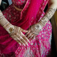 A beautiful example of a modern design using negative space. The elegant lotus motifs on the back of the hand create a bold statement without full coverage.