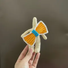 Here are the first completed parts of the Clara Doll. You can see the body and the large bow, all crocheted and ready for assembly.