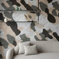 One wall of the drawing room in The House of Dancing Screens features this unique abstract painting crafted from an assortment of natural stones. The intricate design combines various marbles to create a visually appealing masterpiece.