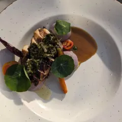 An example of our plated meal artistry: roasted chicken with flat leaf parsley chimichurri and a rich tagine jus. We design multi-course menus that are as beautiful as they are delicious, perfect for formal sit-down dinners.