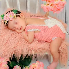 Dreaming peacefully in a soft, floral setting. I use delicate props like this knitted outfit and flower headband to add a touch of sweetness to newborn portraits.