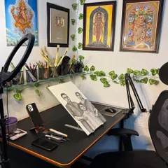 A view of my workspace. This is where I spend hours creating sketches and paintings, surrounded by my tools and completed artworks.