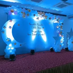 For a magical celebration, we designed this "Twinkle Twinkle Little Star" baby shower stage. The deep blue lighting, crescent moon prop, and cloud-like balloon arrangements create a dreamy atmosphere that guests love.