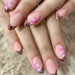 A unique take on the French manicure, with a tortoise shell tip and hand-painted lotus flowers.