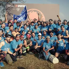 The Running Roadies flag flying high. This is our tribe, celebrating together after conquering the Spartan course. It’s moments like these that define our community.