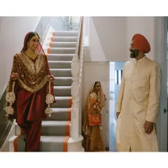 A father looks on as his daughter descends the stairs, ready for her Anand Karaj ceremony. It’s a quiet moment of pride and love, beautifully captured in the family home.