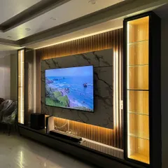 The final TV panel, perfectly matching the 3D render. It features a large screen, soundbar, and illuminated display cabinets, all set against a backdrop of marble and wooden flutes.