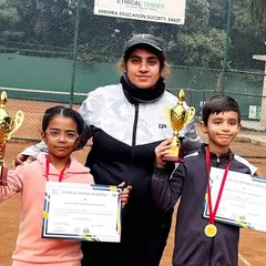 A coach stands proudly with two of our youngest champions from the Saket Ethical Open Tournament. We believe in celebrating every victory, and these big trophies for our U8 players show that the journey to greatness starts with encouragement.