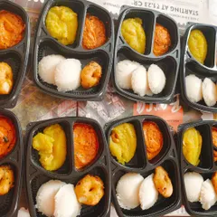 A classic South Indian breakfast order. These boxes contain soft idlis, a crispy medhu vada, flavorful kaara chutney, and sweet kesari for a soulful start to the day.