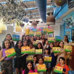The pure joy of a kids' birthday party. A large group of young artists proudly display the vibrant floral canvases they created. This is what it's all about: fun, friendship, and a masterpiece to take home.