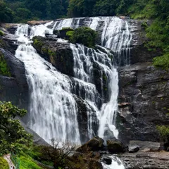 The powerful rush of water cascades down the rocks at a majestic waterfall in Karnataka. This landscape shot beautifully captures the raw power and beauty of nature during the monsoon season.