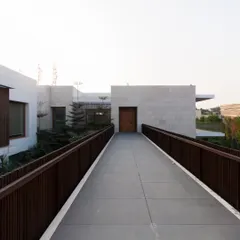 The namesake bridges of this residence are more than just circulation paths. They are architectural devices that connect separate living zones, creating a journey through the home that balances shared spaces with private retreats.