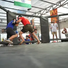 Clinch work against the cage wall. This is where fights are won and lost, testing your strength, balance, and ability to control the opponent in close quarters.