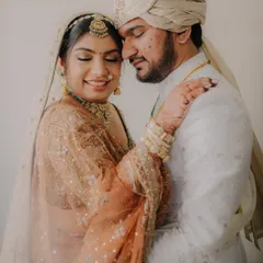 A warm and loving embrace. The couple's closed eyes and gentle smiles convey a sense of deep comfort and happiness in each other's arms.