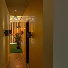 A view down a corridor in our marriage hall design. We use strategic lighting, planters, and wall textures to ensure that even transitional spaces are elegant and well-designed.