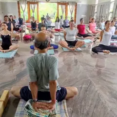 Leading a class in our spacious, light-filled yoga hall at the Ramanagara centre. The marble floors and open design create a calm and focused atmosphere for practice.