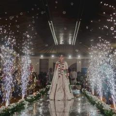 The bride's grand entrance down a mirrored aisle. I lined the walkway with cold pyro fountains that erupted as she walked, creating a dazzling and dramatic path to her groom.