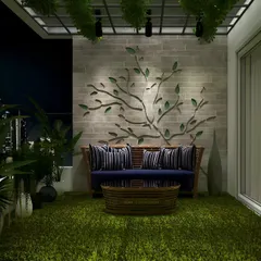 This night-time view shows how lighting can create drama and art. Spotlights highlight a beautiful tree branch wall sculpture, while the surrounding plants are softly illuminated, turning the balcony into a private, moody retreat.