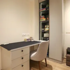 We designed this compact unit for a teen's room, combining a study desk with drawers and an adjoining storage unit with open, lit shelves and closed cabinets.