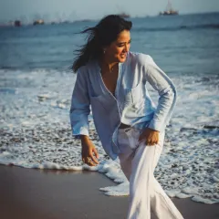 Capturing pure, uninhibited movement on the shore. The motion of the waves and the wind in her hair gives this shot a fresh, spontaneous feel.