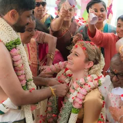 A candid moment of joy during the wedding rituals. The groom's traditional veshti drape remains perfectly in place, even amidst the celebration and movement.