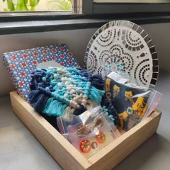 For this hamper, I combined a dark blue macrame purse with a set of my handmade earrings and a mirror mosaic wall hanging. It’s a perfect blend of personal accessories and home decor.