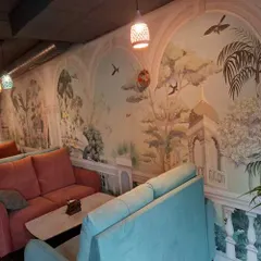 I designed and installed this serene, scenic mural for a local cafe in Bengaluru, creating an elegant and inviting atmosphere. The arched panels give the illusion of windows looking out onto a tranquil landscape, enhancing the customer experience.