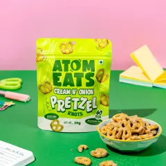 A playful desk setup with a pack of pretzel knots, styled with colorful stationery. This shot positions the snack as the perfect study or work break companion.