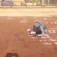 Proper surface preparation is key to effective waterproofing. My process begins with meticulously filling every crack and grout line on the terrace tiles to create a solid, uniform base before applying the final waterproof layers.