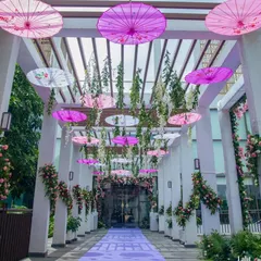 The entrance to this engagement party was decorated with a pergola structure, a lavender carpet, and hanging Japanese-style umbrellas for a whimsical, romantic touch.