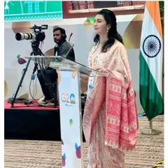 At the podium for a G20 event, with the Indian flag proudly beside me. These moments are a profound responsibility, requiring a formal and respectful tone to represent our nation's hospitality and vision.