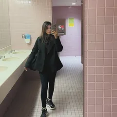 A mirror selfie showcasing a full college look: black coat, leggings, and chunky sneakers. This is a classic "outfit dump" photo that is very popular with student audiences.