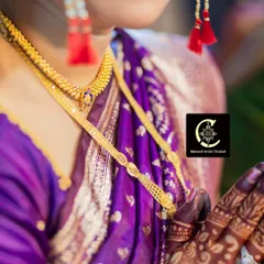 A close up of the bride's hands, showcasing the stunning contrast between the dark mehendi stain and her traditional gold jewelry and purple saree.