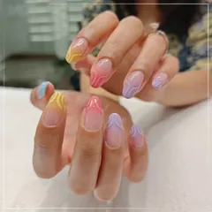 Add a touch of color and texture to your look. This unique nail art features a pastel rainbow gradient with a subtle 3D wave design on a clear base for a modern and playful style.