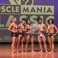 The lineup of champions at Muscle Mania India. My client is right there in the middle, holding the plaque, a testament to his hard work and my coaching.