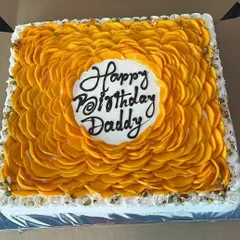 A large, rectangular Mango Overload Cake made for a special birthday celebration. This shows how we can scale our popular seasonal cakes for bigger parties and events.