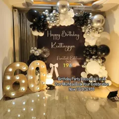 A sophisticated black, white, and silver theme for a 60th birthday. The custom backdrop, balloon arch, and large marquee numbers create a classy and memorable "Limited Edition" look.
