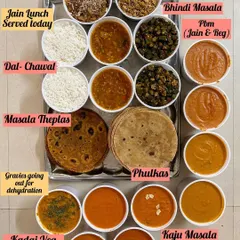 A glimpse into a busy day of cooking. This spread includes a Jain lunch with Dal Chawal and Sheera, alongside gravies like Kaju Masala and Kadai Veg being prepared for dehydration.