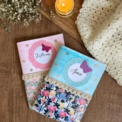 The personalized covers for two custom journals I created for a client whose daughters were moving abroad. The journals were designed to help them process the transition and document their new journey.