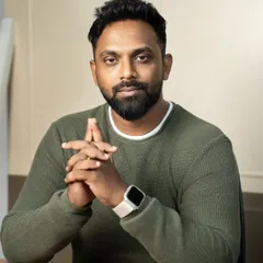 A clean and confident professional headshot, perfect for making a strong impression on LinkedIn or a company website. The focus here is on approachability and professionalism, achieved with simple studio lighting and a relaxed, direct-to-camera pose.