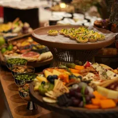 Another view of the lavish spread for the HT100 event, featuring multiple tiers of grazing boards, nut bowls, and elegant canapés, designed to impress a discerning corporate audience.