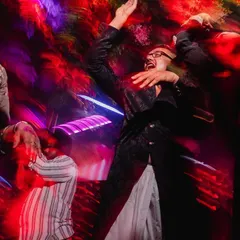 A guest letting loose on the dance floor, captured with a dynamic motion blur effect. We love capturing the uninhibited fun of a great wedding party.
