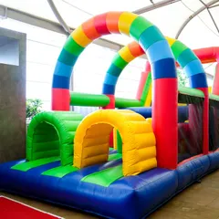 A long, rainbow-colored inflatable obstacle course that challenges kids to crawl, climb, and slide their way to the finish line.
